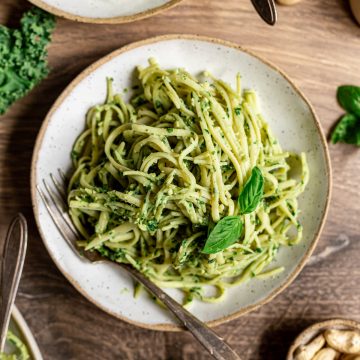 A bowl of pasta tossed with kale cashew basil pesto.