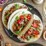 A plate of three mushroom walnut tacos.