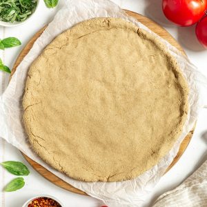 A baked oat flour pizza crust, ready to top.