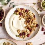 A bowl of vegan yogurt topped with oil free granola.