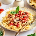 A bowl of oil-free vegan spaghetti sauce on top of spaghetti.