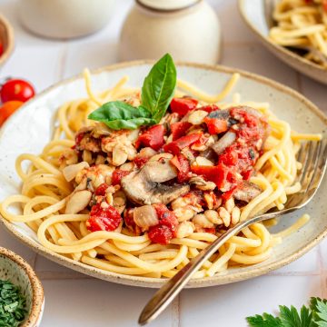 A bowl of oil-free vegan spaghetti sauce on top of spaghetti.