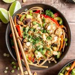 A bowl of plant-based pad thai with chopsticks.