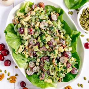 A platter of plant-based waldorf salad on a bed of lettuce.