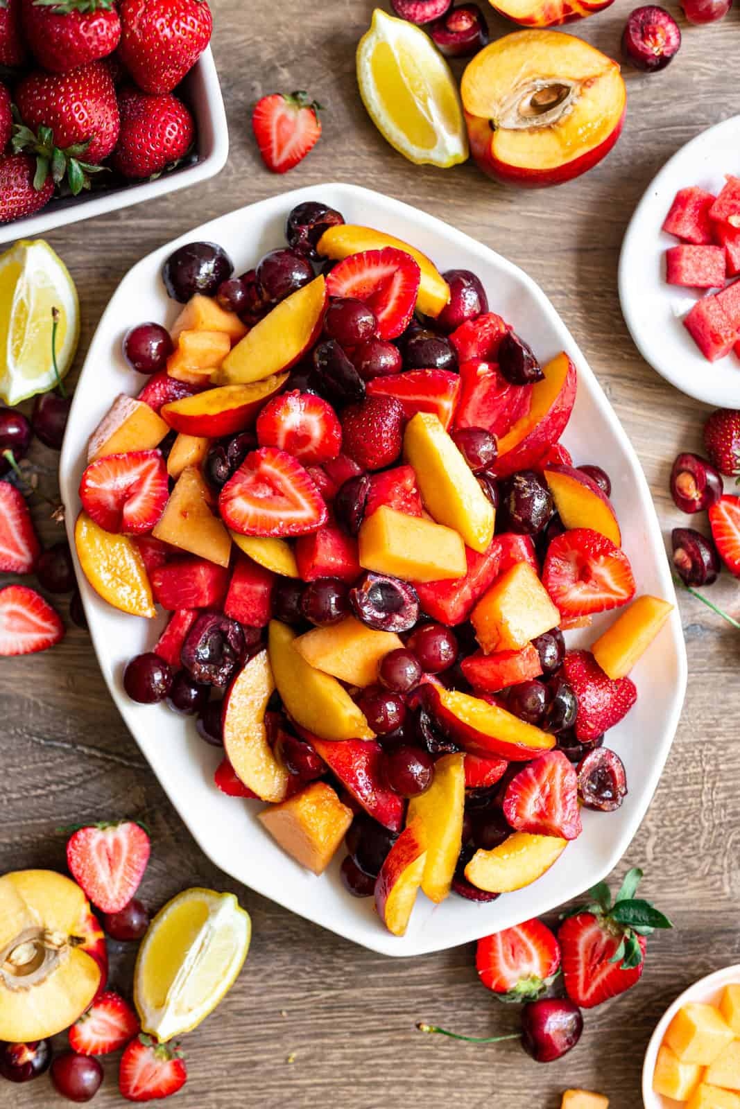 A large platter of red fruit salad.