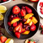 A bowl of red fruit salad.