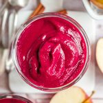 A beet apple smoothie in a glass.