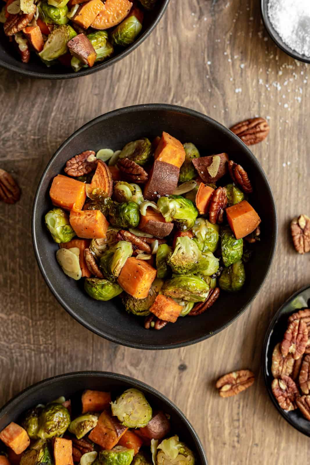 A bowl of roasted brussels sprouts and sweet potatoes.