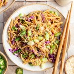 A bowl of spicy garlic noodles, with chopsticks.