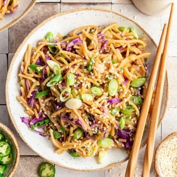 A bowl of spicy garlic noodles, with chopsticks.