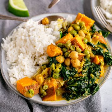 A plate of sweet potato coconut curry served with rice.