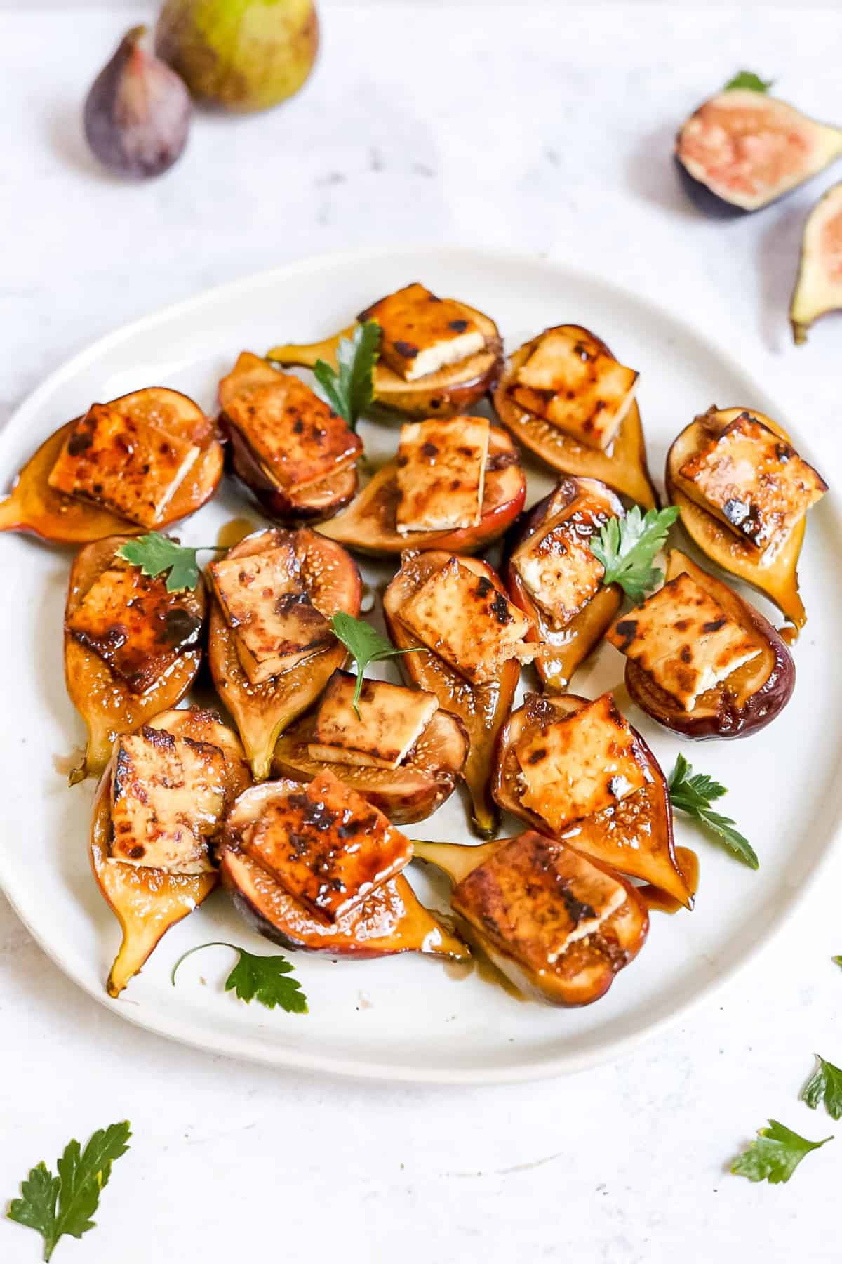 A plate of tofu bacon topped figs.