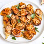 A plate of tofu bacon topped figs.