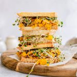 A stack of tofu scramble breakfast sandwiches.