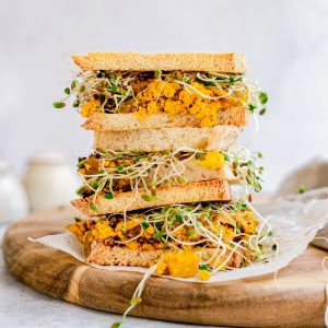 A stack of tofu scramble breakfast sandwiches.