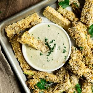 A tray of zucchini fries, with a bowl of aioli.