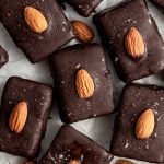 Several vegan almond joy bars on a sheet of parchment paper.