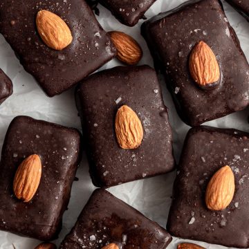 Several vegan almond joy bars on a sheet of parchment paper.