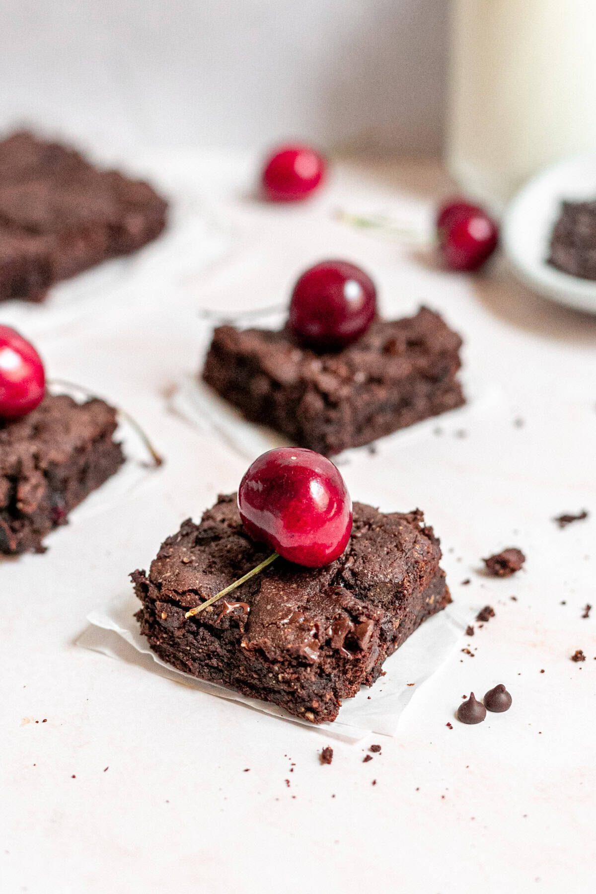 Vegan black forest brownies topped with cherries.
