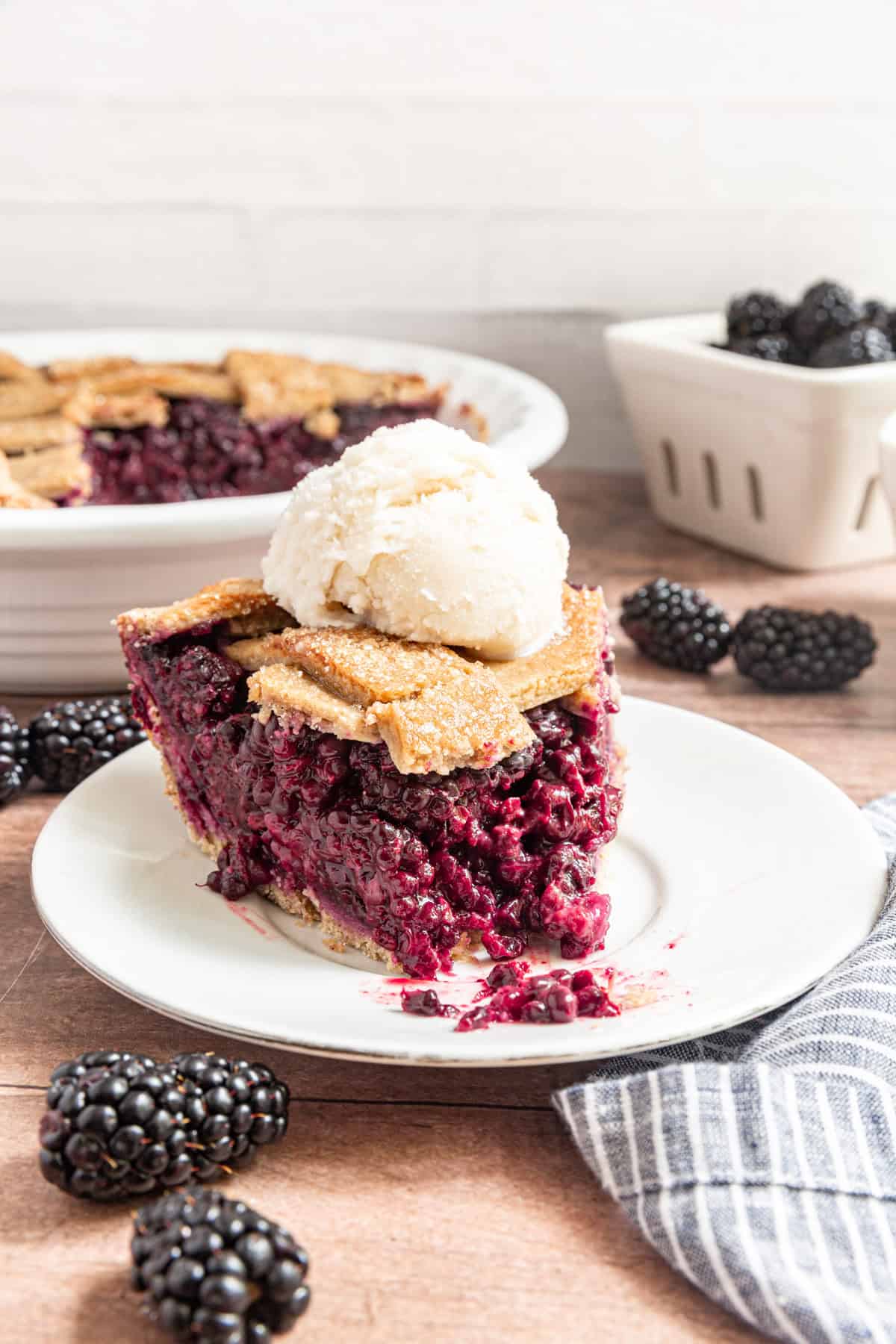 A slice Vegan Blackberry Pie with a bite taken out.