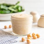 A mason jar of vegan chickpea dressing.