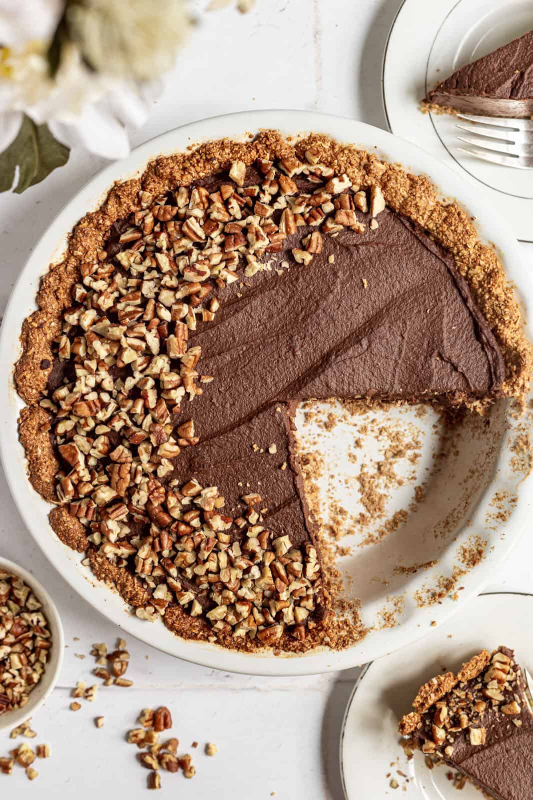 Vegan chocolate pie with a slice removed.