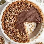 Vegan chocolate pie with a slice removed.