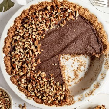 Vegan chocolate pie with a slice removed.