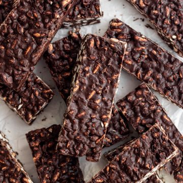 A bunch of vegan crunch bars on a piece of parchment paper.