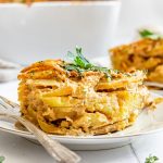 A serving of scalloped potatoes on a plate.