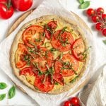 Vegan margherita pizza freshly baked and ready to slice.