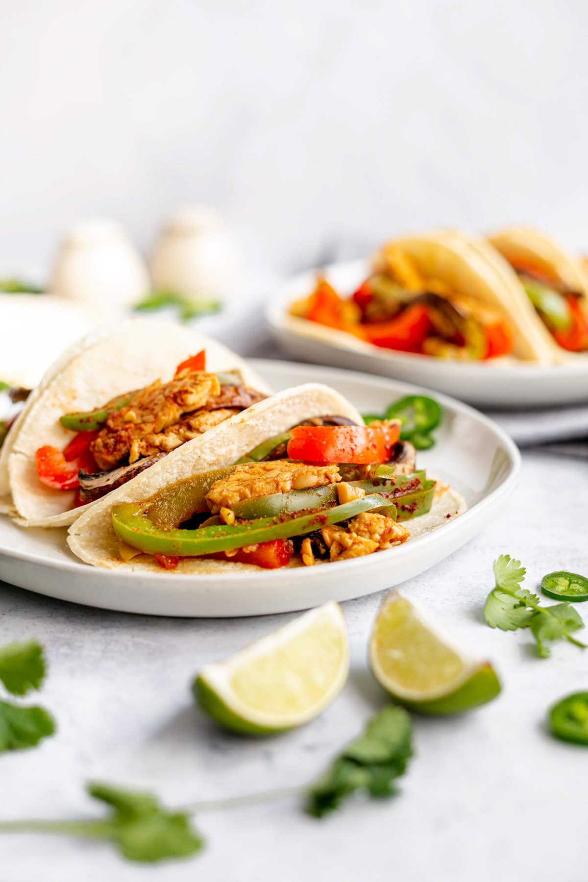 A plate with three mushroom tempeh fajitas.
