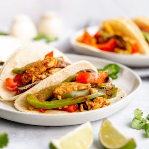 A plate with three mushroom tempeh fajitas.