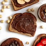 A piece of toast spread with vegan nutella.