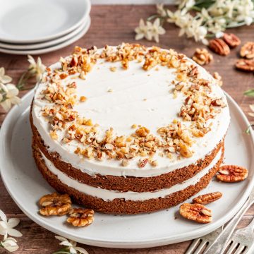 An iced vegan carrot cake, ready to serve.