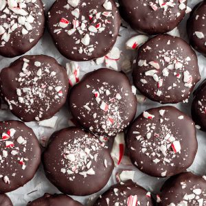 Rows of peppermint patties on parchment paper.