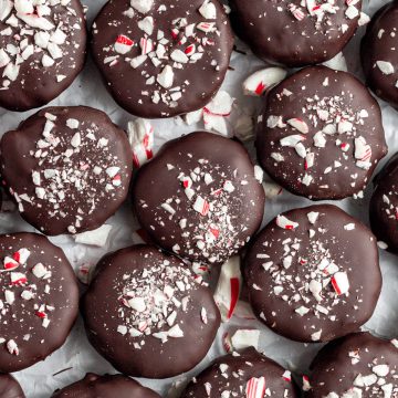 Rows of peppermint patties on parchment paper.