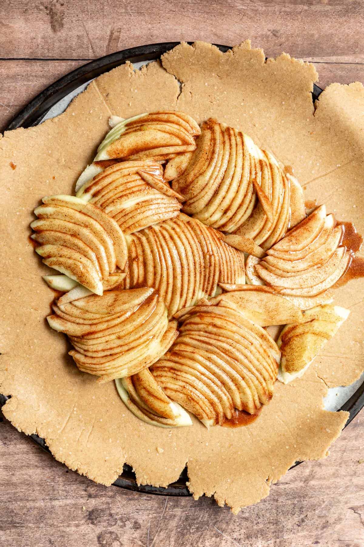 An apple galette in process, ready for the crust to be folded.