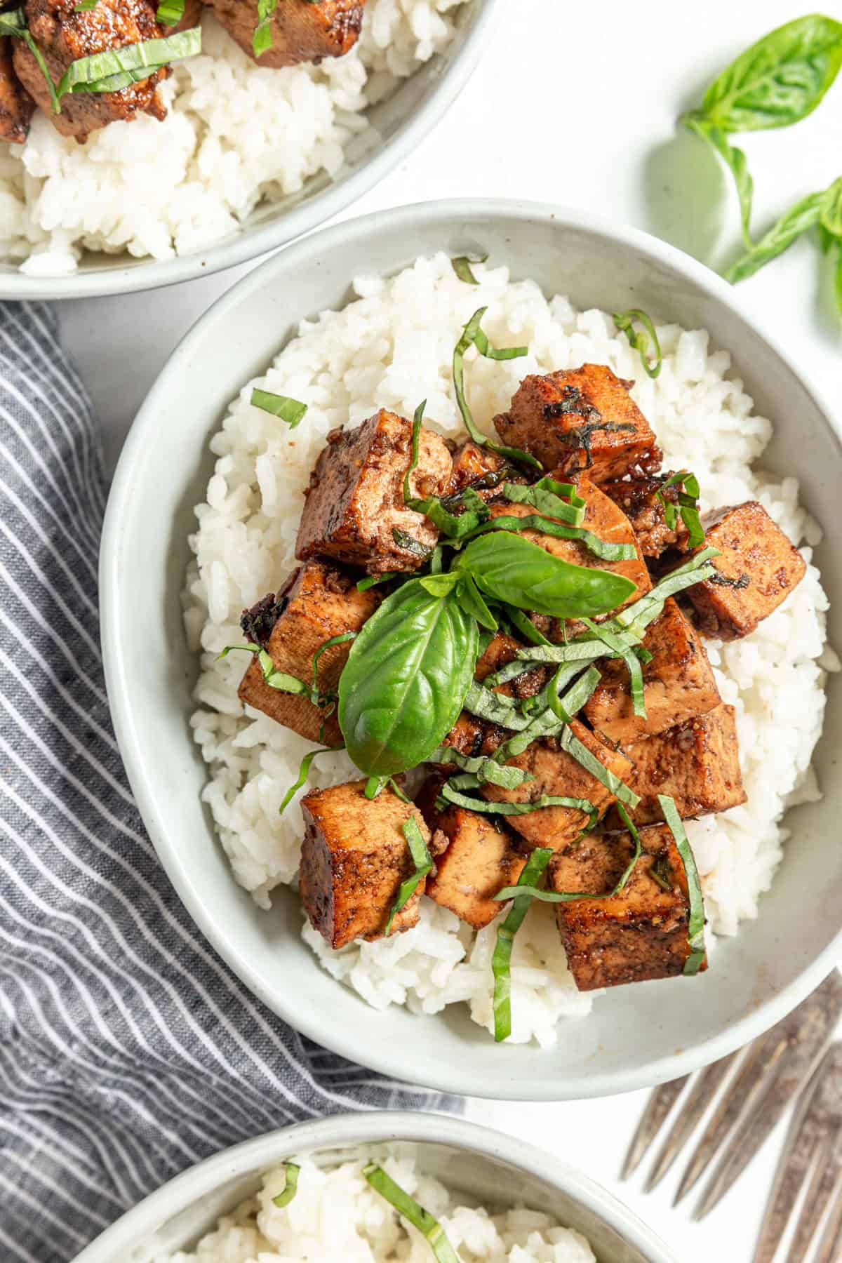 Basil Balsamic Marinated Tofu served in bowls with rice.