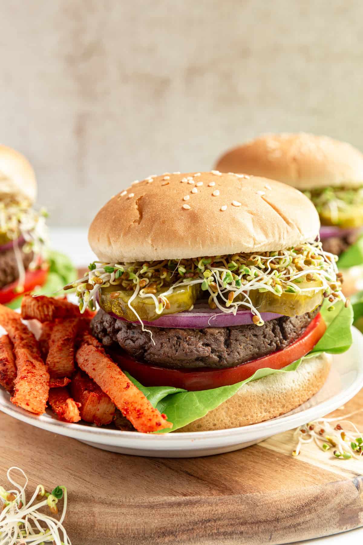 A plate with a Vegan High Protein Seitan Burger and some jicama fries.