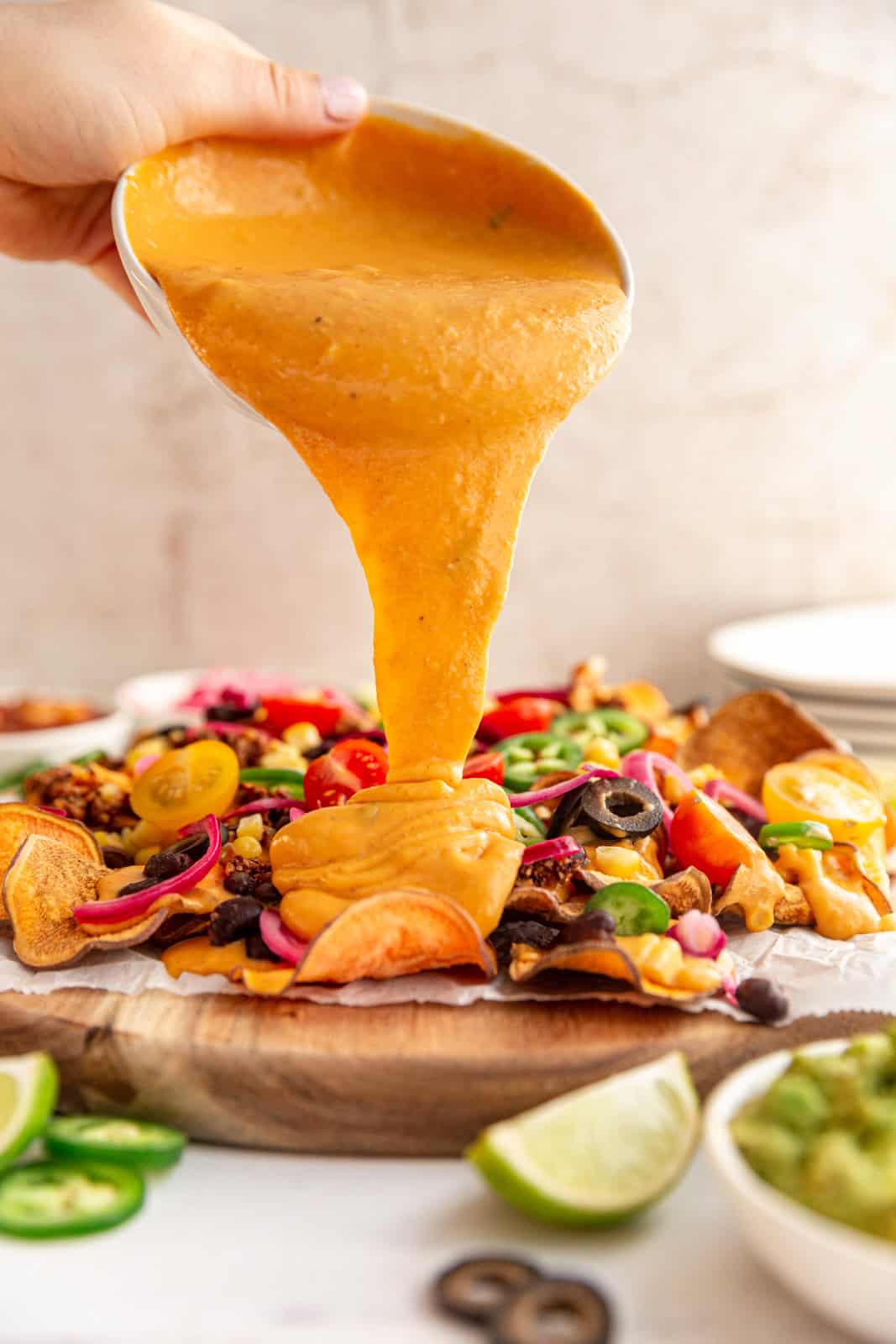 Vegan Queso poured over nachos