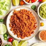 A bowl of TVP taco meat, with bowls of taco toppings.