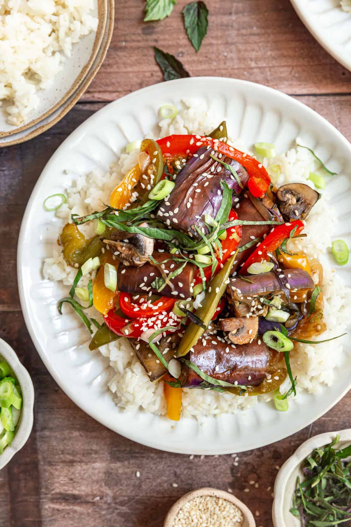 A plate of Thai Basil Eggplant Stir Fry served over rice.