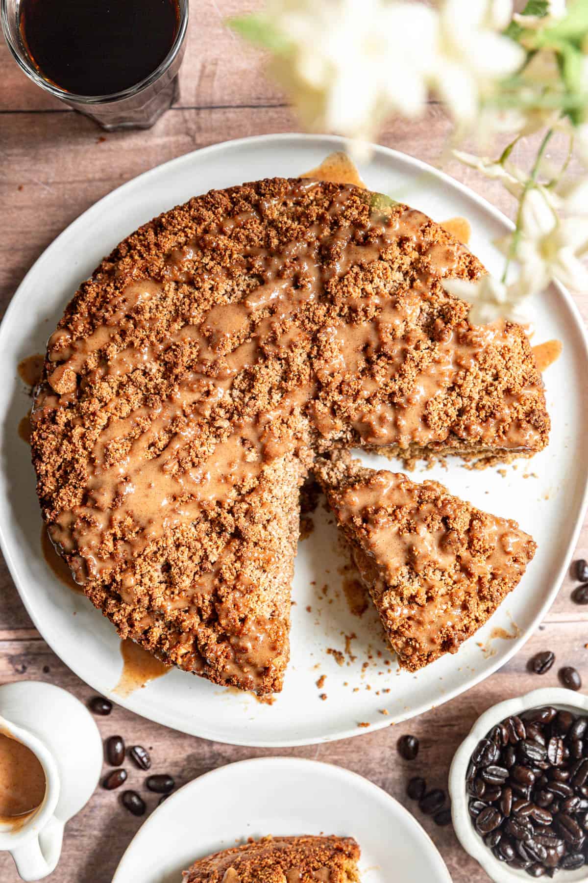 A sliced vegan coffee cake with a piece removed.