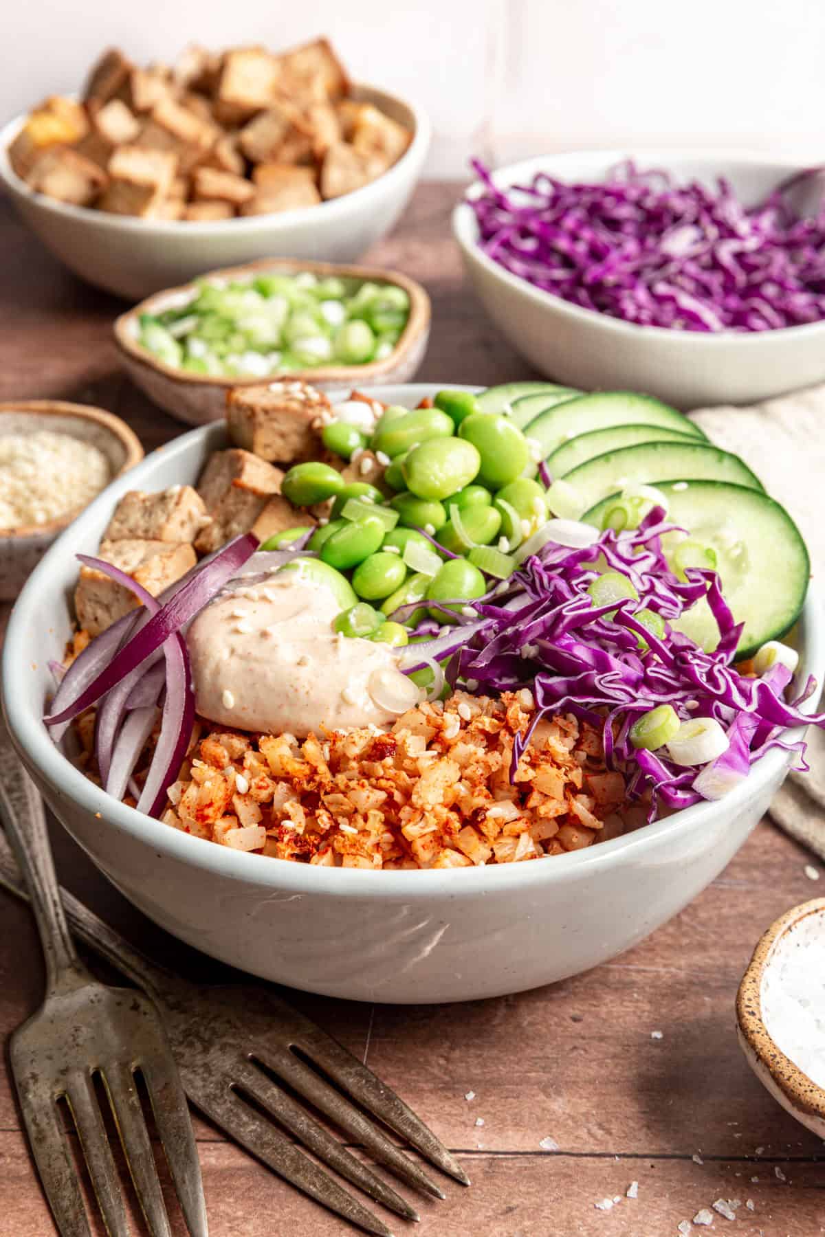 Air Fryer Cauliflower Rice Bowls surrounded by ingredients.