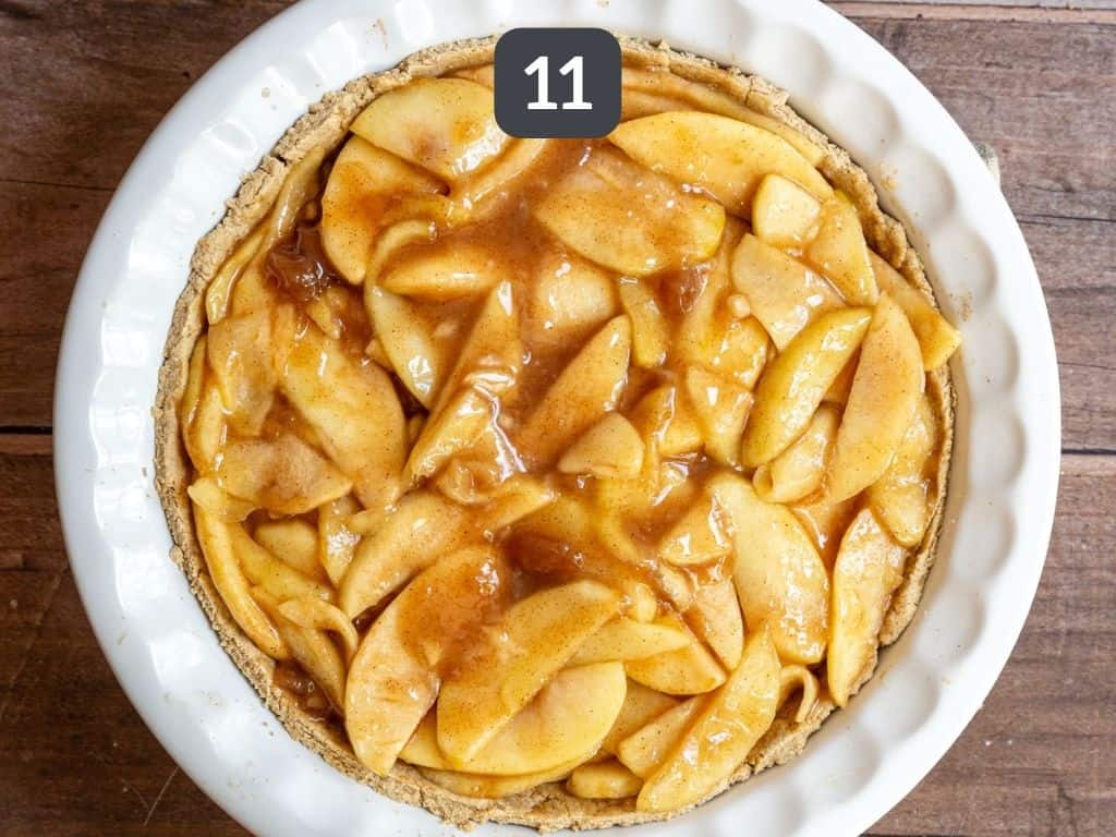Gluten free vegan apple pie step 11 - press the apples into the baked crust.