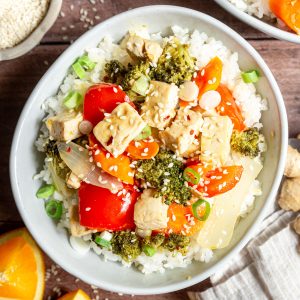 A bowl of Vegan Orange Tofu and vegetables served over rice.
