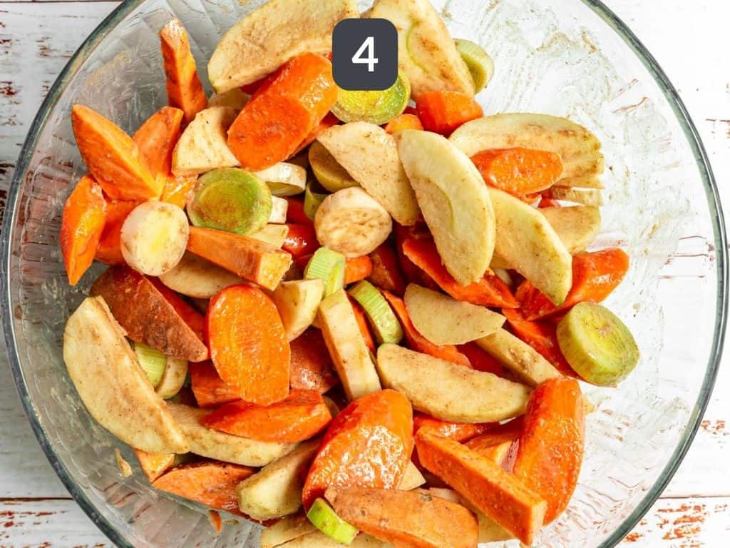 Sheet pan tempeh step 4 - toss the vegetables in the tahini sauce.