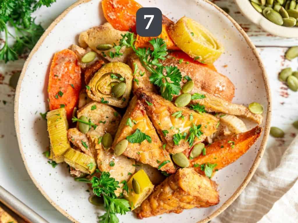 Sheet pan tempeh step 7 - serve with parsley and pumpkin seeds.