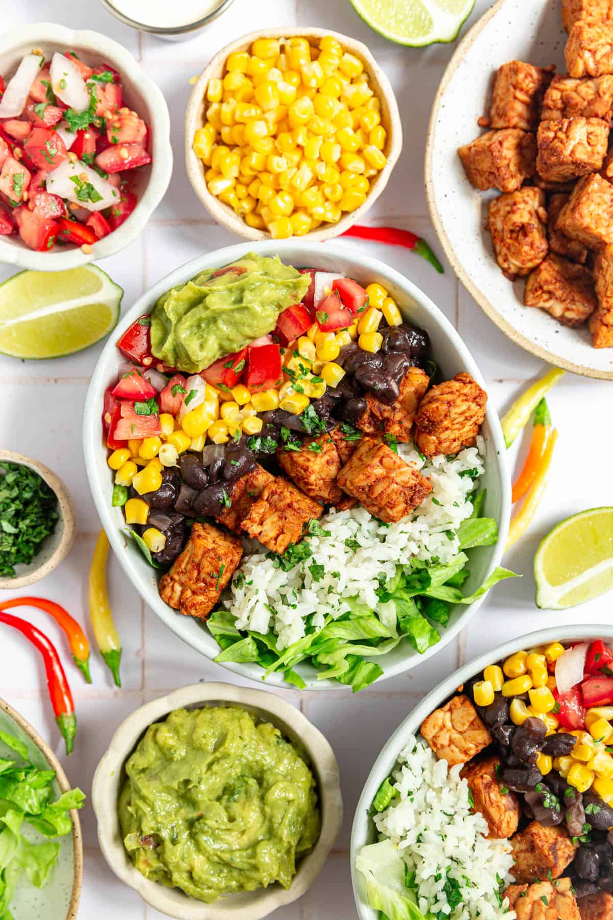 A tempeh burrito bowl loaded with veggies and toppings.